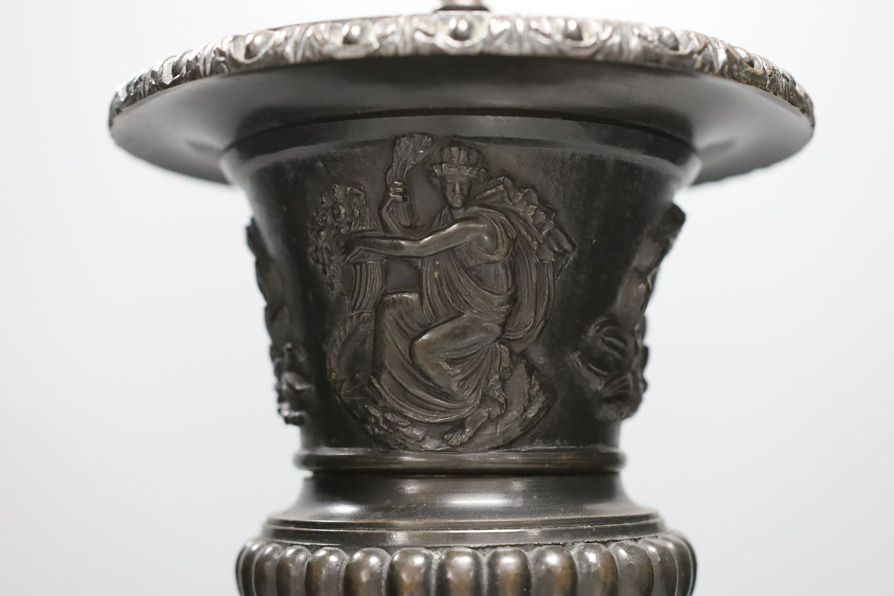 A bronze urn lamp on stepped serpentine base. Total height 49cm